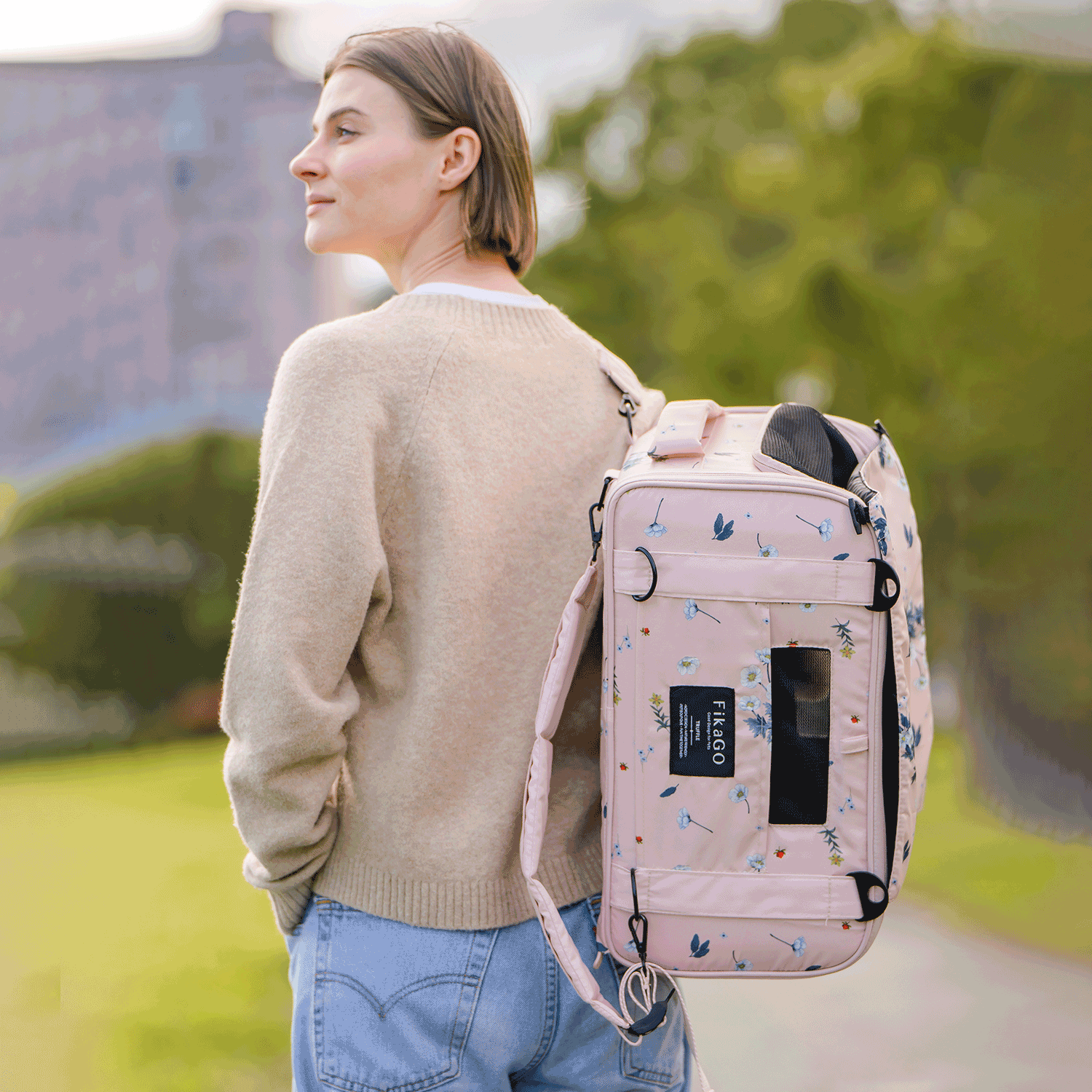Person wearing FikaGO TRUFFLE carry-on pet bag as a backpack in arctic flower