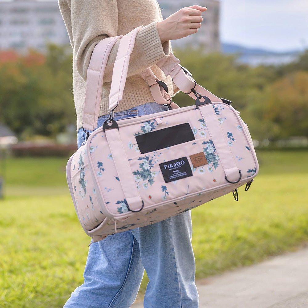 Woman carrying FikaGO TRUFFLE carry-on pet bag by one hand in arctic flower