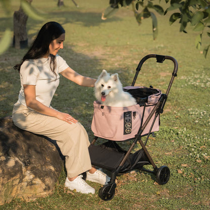 FikaGO FREE TO GO 2 pet stroller with a dog and its owner on grass in mist pink