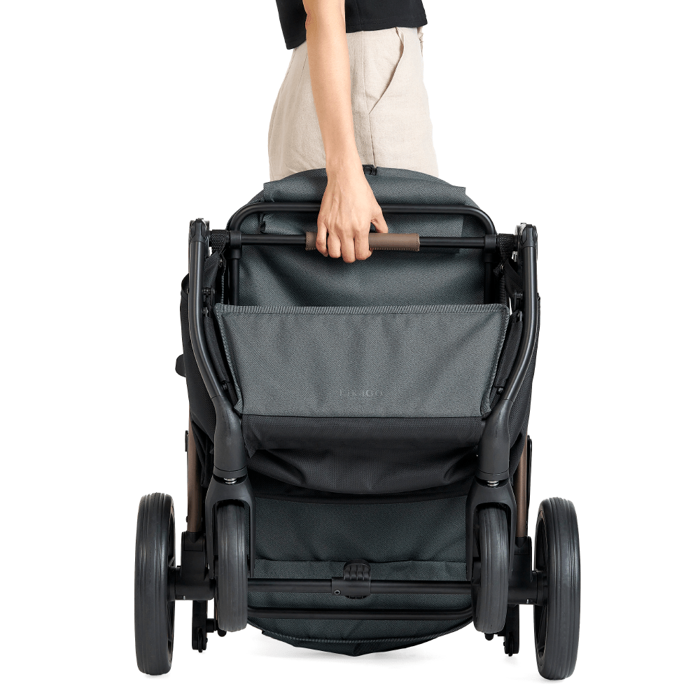 A lady is holding a folded FikaGO AGILE 2 pet stroller 